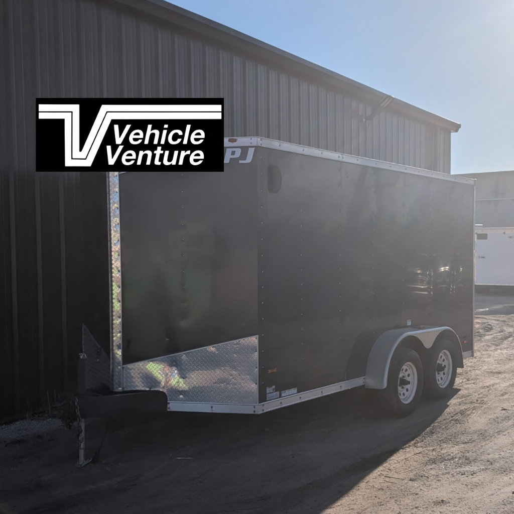 A 2015 MTI 7X14 Enclosed Ramp Door trailer in black with two axles is parked outside a metal building. The Vehicle Venture logo appears in the top left corner.