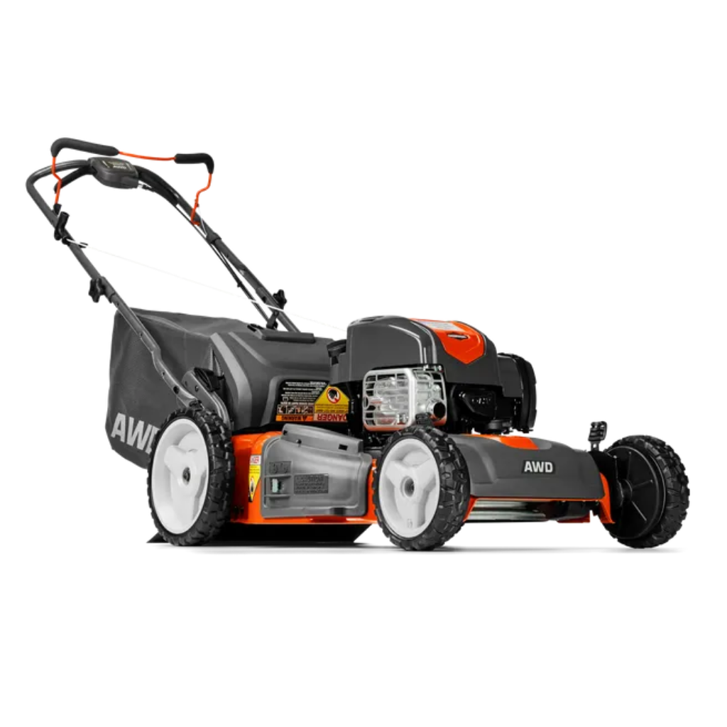 A USED HUSQVARNA HU725AWDH 006189 walk-behind mower in orange and black, gas-powered with all-wheel drive and a rear grass collection bag.